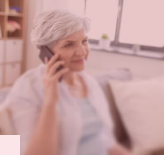 An older patient speaking with the Glia voice agent by phone